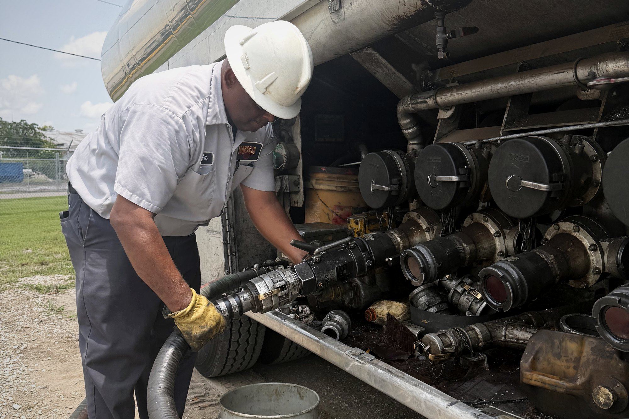 Marcello crew running a hose during an on-site farm fuel drop